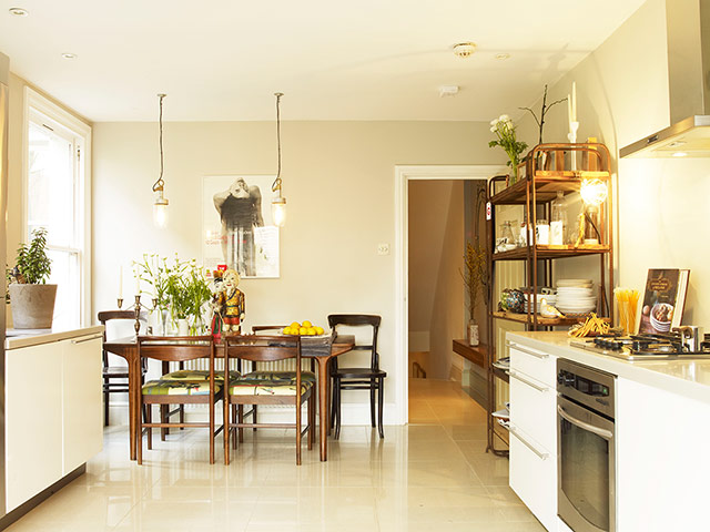 Homes - Economy Class: kitchen with cream walls and wooden table