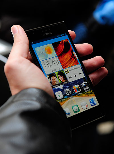 Mobile World Congress: A visitor holds Huawei's Ascend P2, claimed to be the world's smartphone