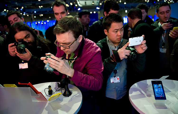 Mobile World Congress: Visitors take pictures of a new Nokia device