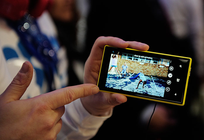 Mobile World Congress: A visitor holds the new Nokia Lumia 720
