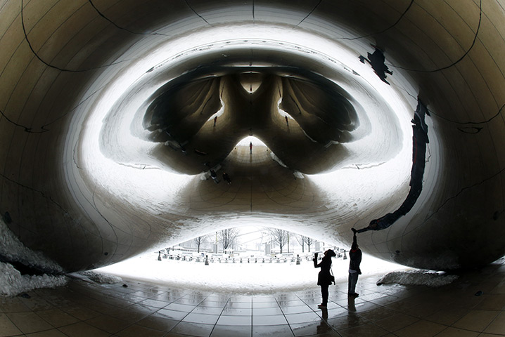 24 hours: Chicago, US: people walk under Anish Kapoor's stainless steel Cloud Gate