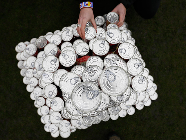 24 hours: London, England: a Unite Union worker places cans of soup 