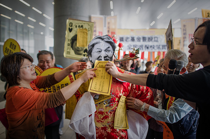 24 hours: Demonstrators apply leaflets onto a pict