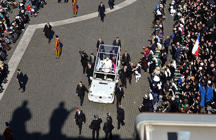 Pope Benedict XVI update: Pope Benedict XVI in his popemobile as a nun tries to reach the car