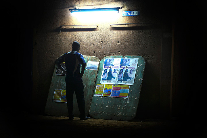 FTA: Nic Bothma: A man looks at film posters outside the open air Cinema Patte d’Oie 