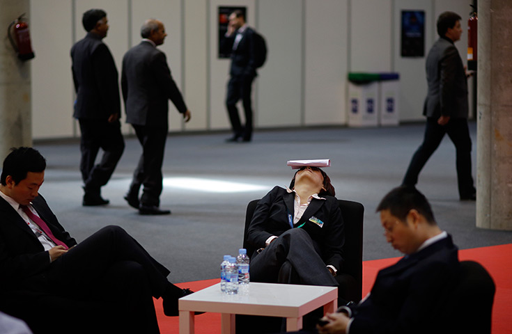 24 hours in pictures: An attendee sleeps mobile phone trade show, in Barcelona