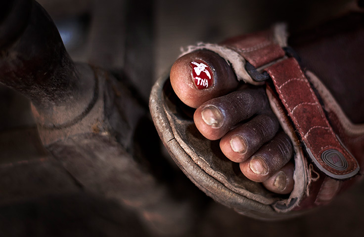 24 hours in pictures: toenail painted with the initials of presidential candidate Uhuru Kenyatta