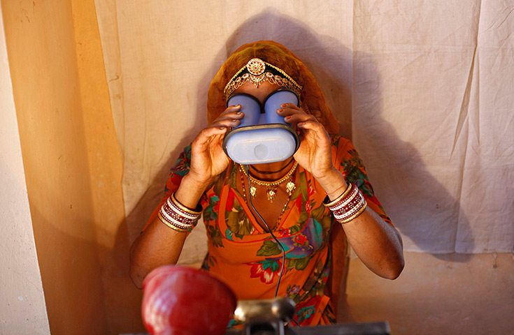 24 hours in pictures: A villager goes through the process of eye scanning 