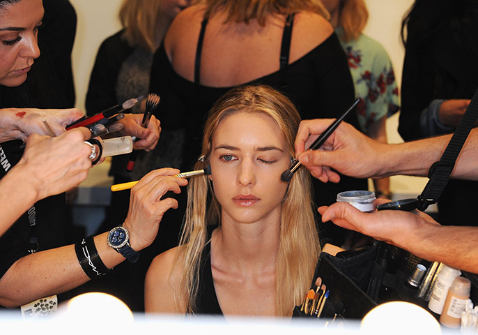 A lighter look: A model is prepared behind the scenes at London fashion week