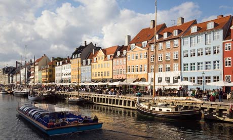 COPENHAGEN DENMARK Nyhavn, waterfront cafes bars and restaurants and tour boat on canal.