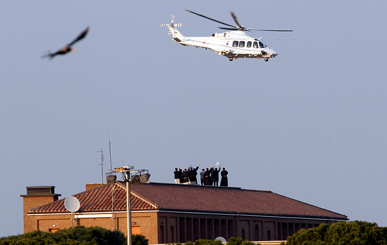 The Pope's last day: Priests wave as the helicopter carrying Pope Benedict XVI takes off