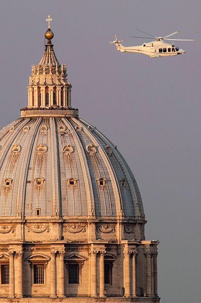 The Pope's last day: People crowd into the gallery on top of St Peter's Basilica
