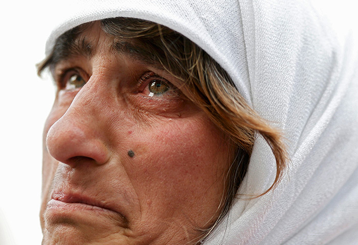 The Pope's last day: A woman reacts near a giant screen
