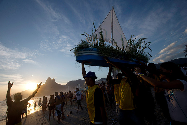 24 hours: Rio de Janeiro, Brazil: People carry a boat filled with flowers