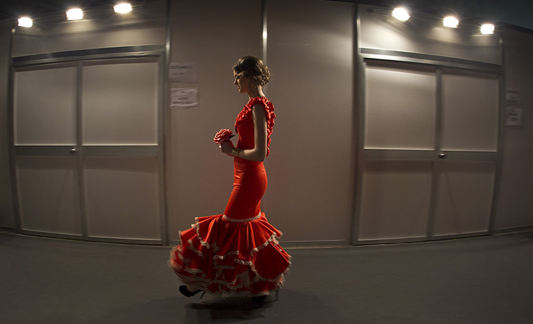 24 hours: Seville, Spain: A model walks backstage during the flamenco fashion show 