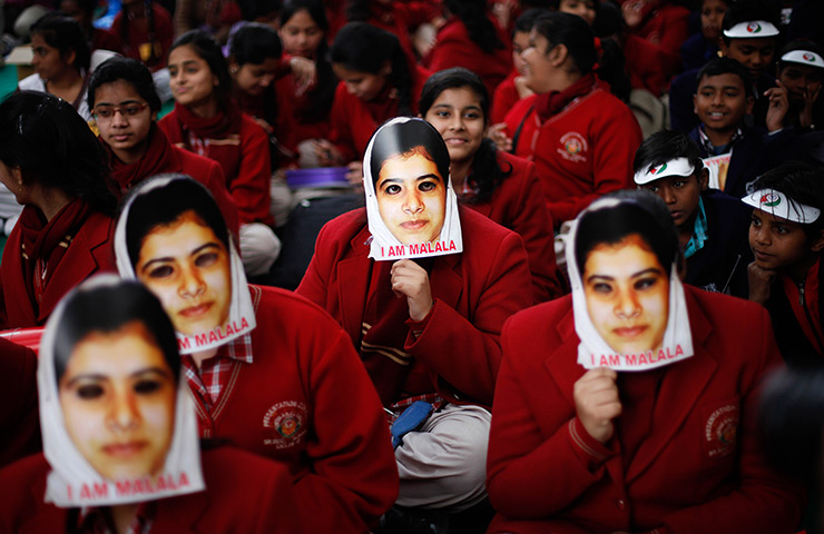 24 hours: New Delhi, India: Schoolgirls wear masks of Malala Yousufzai