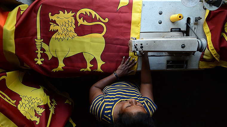 24 hours: Colombo, Sri Lanka: A tailor stitches national flags