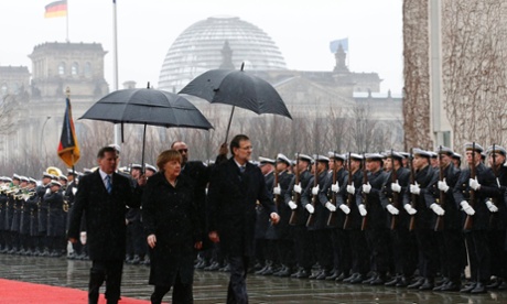German Chancellor Angela Merkel and Spanish Prime Minister Mariano Rajoy inspect the guard of honour during a welcome ceremony before talks at the Chancellery in Berlin February 4, 2013.