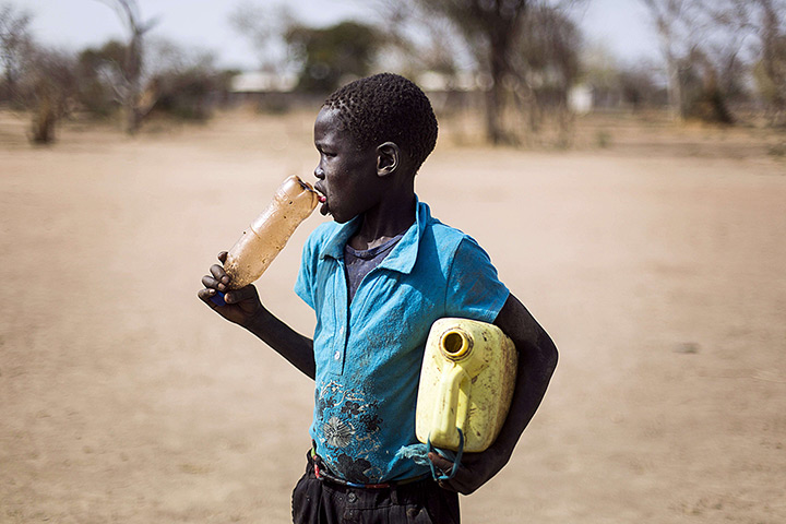 24 hours: JanJang, South Sudan: A South Sudanese child carries an empty jerrycan