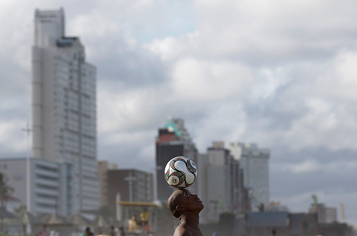 24 hours: Durban, South Africa: A boy balances a ball on his head
