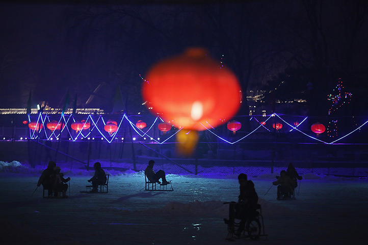 24 hours: Beijing, China: Tourists ride on specially constructed ice-chairs