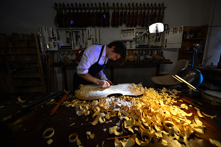 24 hours: Rome, Italy: Mathias Menanteau works on a cello body in his workshop