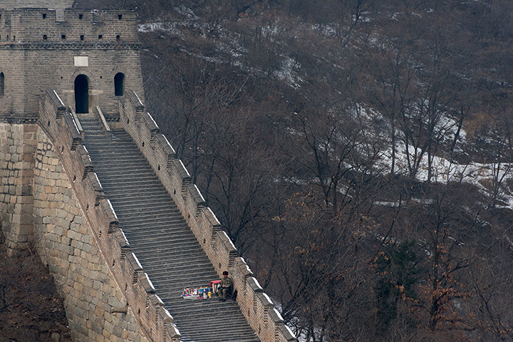 24 hours: Mutianyu, China: A hawker waits for customers 