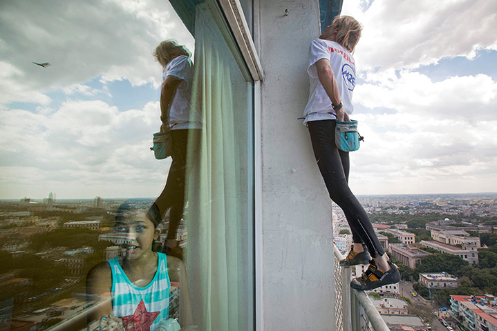 24 hours: Havana, Cuba: French daredevil Alain Robert reaches into his chalk bag