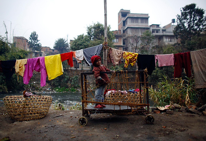 24 hours: Kathmandu, Nepal: A child plays on a cart