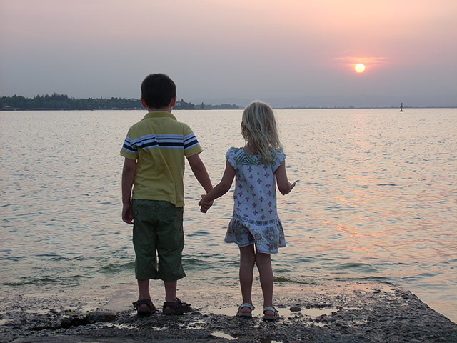 Your Pictures: Love: boy and girl standing near a lake looking out to sunset