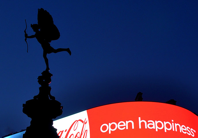 Your Pictures: Love: Eros statue silhouette against coca-cola sign