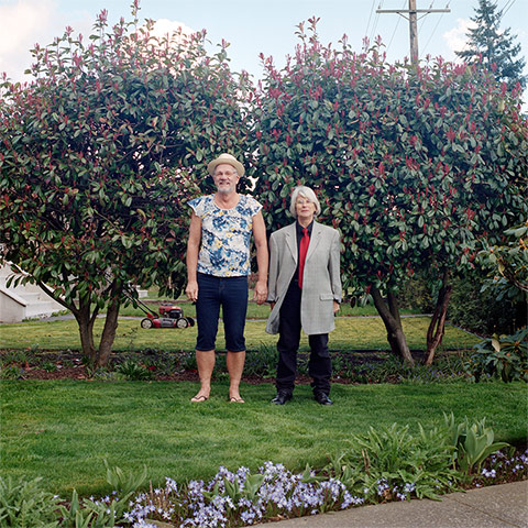 Big Picture - Hana Pesut: couple clothes swapping hana pesut switcheroo man wearing floral top and cropped trousers woman wearing oversized jacked and black trousers