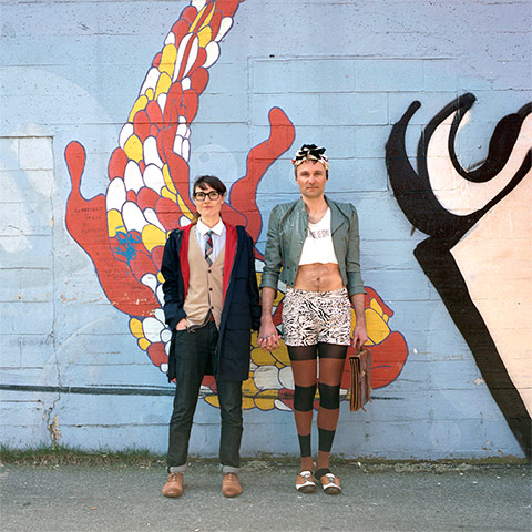 Big Picture - Hana Pesut: couple clothes swapping hana pesut switcheroo woman wearing jeans and cardigan with shirt and tie man wearing cropped top and hotpants