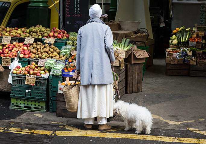 Borough Market: A shopper and her dog take a look at a fruit and veg stall.