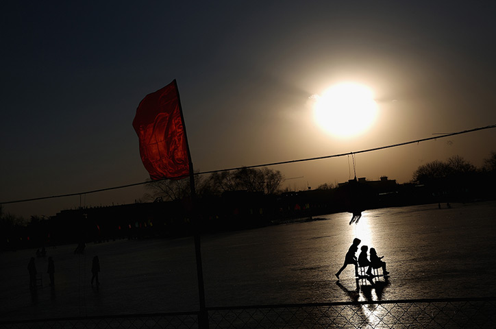 24 hours in pictures: Tourists ride on specially constructed 'ice-chairs' on the frozen Lake