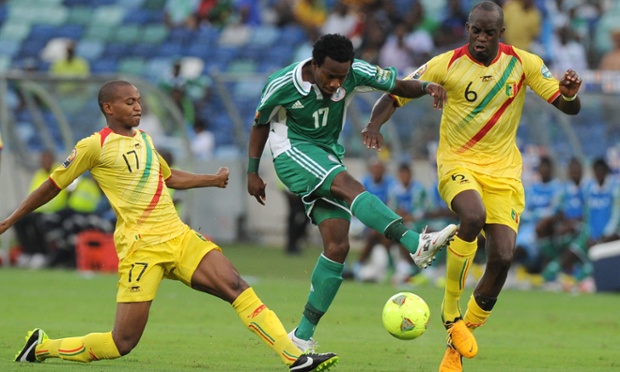 Nigeria's midfielder Ogenyi Onazi is tackled.