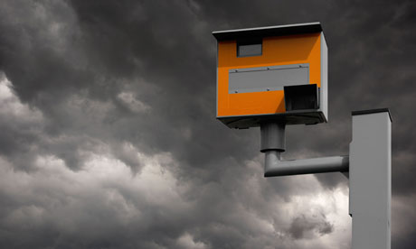 YELLOW GATSO ROAD SAFETY SPEED CAMERA AGAINST STORMY GREY SKY