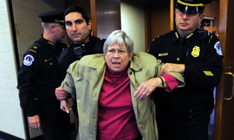 An anti-war protester is removed by police.