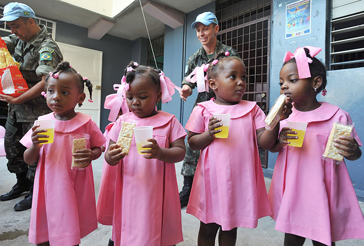 24 Hours: Port-au-Prince, Haiti: Brazilian UN peacekeepers distribute juice