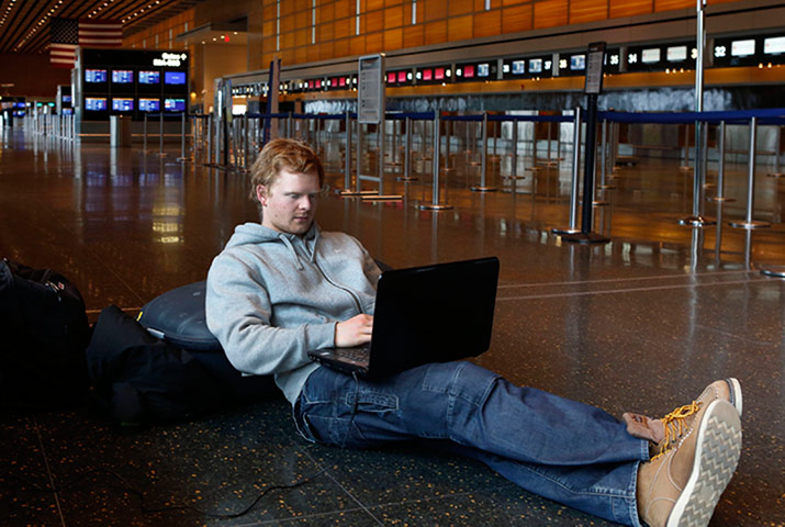 us blizzard: Passengers wait at Logan Airport 