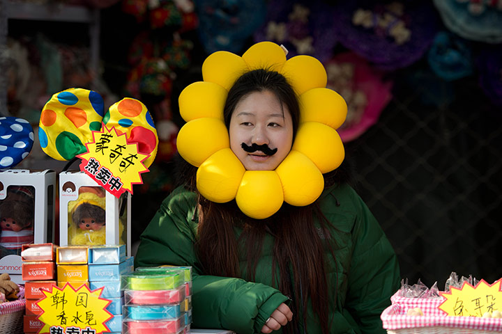 Lunar New Year: A vendor waits for customers at her stall at a temple fair in Ditan Park, Beijing 