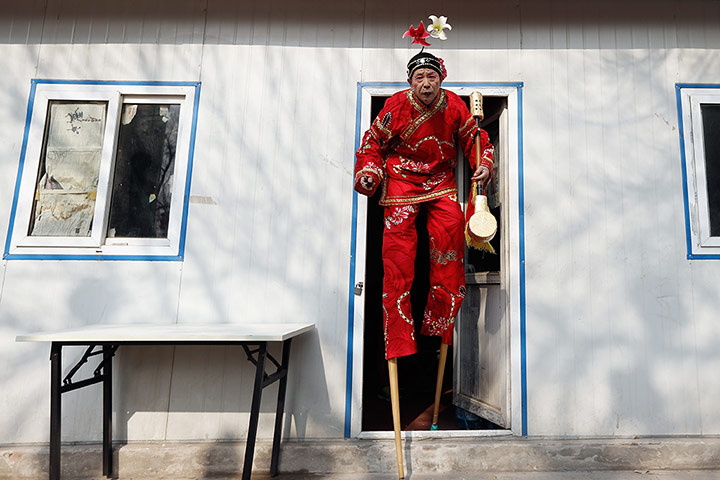 Lunar New Year: A Chinese folk artist prepares to perform during the opening ceremony of the Spring Festival Temple Fair at Dragon Lake Park in Beijing, China