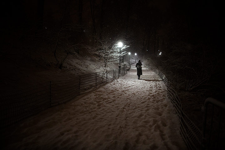 US snow: A pedestrian walks along a snowy path in Central Park