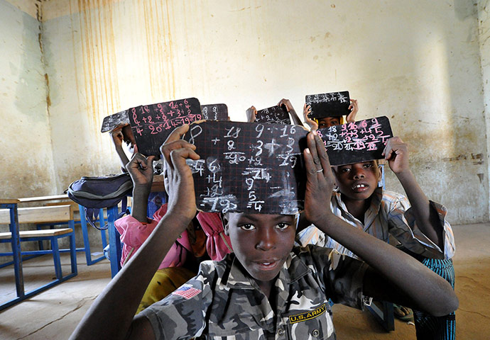 20 Photos: Students hold up thier chalk boards in Gao, Mali