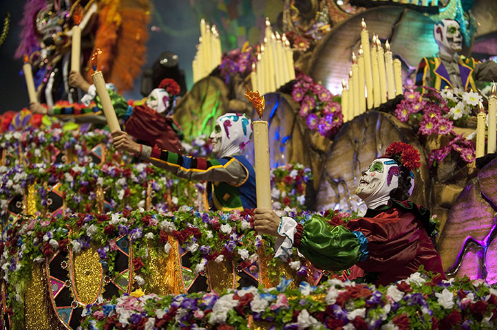 24 hours: Revellers of Rosas de Ouro samba school perform atop a float during the first night of carnival parades in São Paulo, Brazil