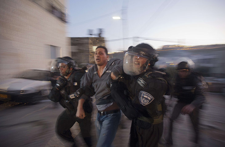 24 hours: Israeli forces arrest a Palestinian man during clashes in Jerusalem