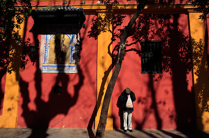 24 hours: A man lights a cigarette in the Andalusian capital of Seville