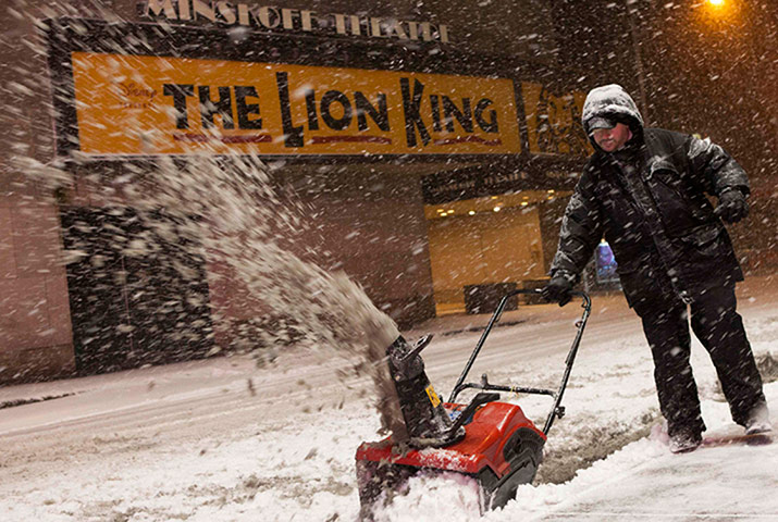 saturday blizzard: A man operates a snow plow in New York