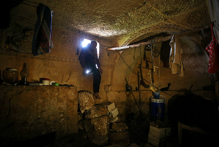 24 hours in pictures: Man steps into an underground Roman tomb used for shelter 