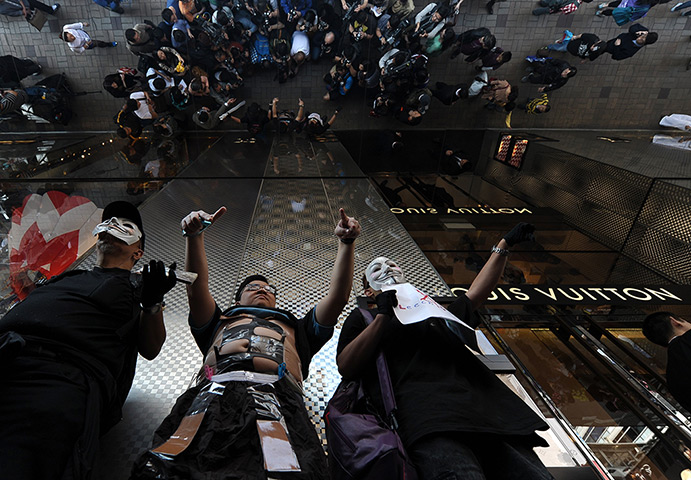 24 hours: Hong Kong, China: A protester outside Louis Vuitton